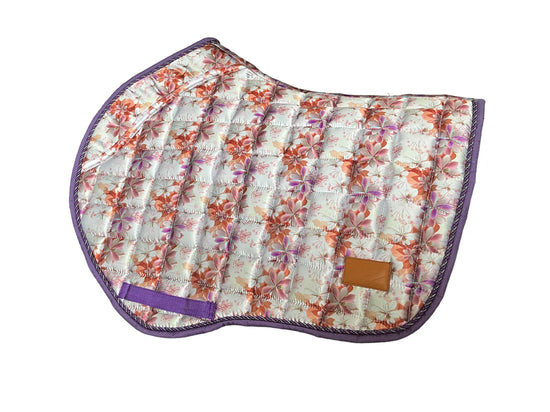 Spring Bloom floral jump saddle pad with purple trim on grass