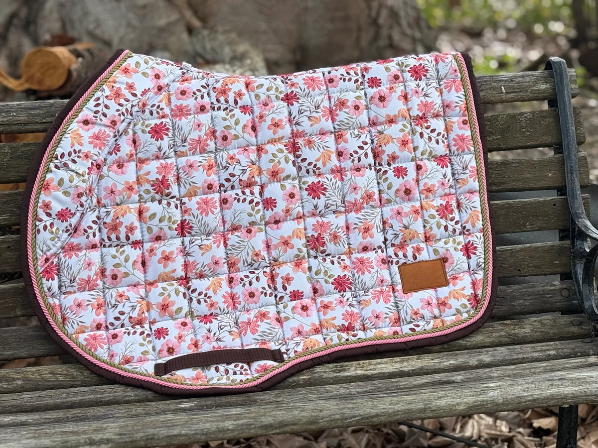 Blush floral jump saddle pad on white background