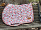 Blush floral jump saddle pad on white background